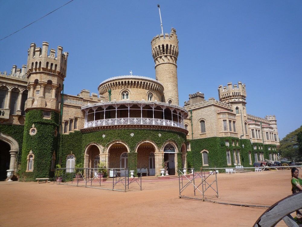 Bangalore Palace med murgröna och torn Historiska Bangalore Palace med murgrönstäckta väggar och medeltida torn under klarblå himmel