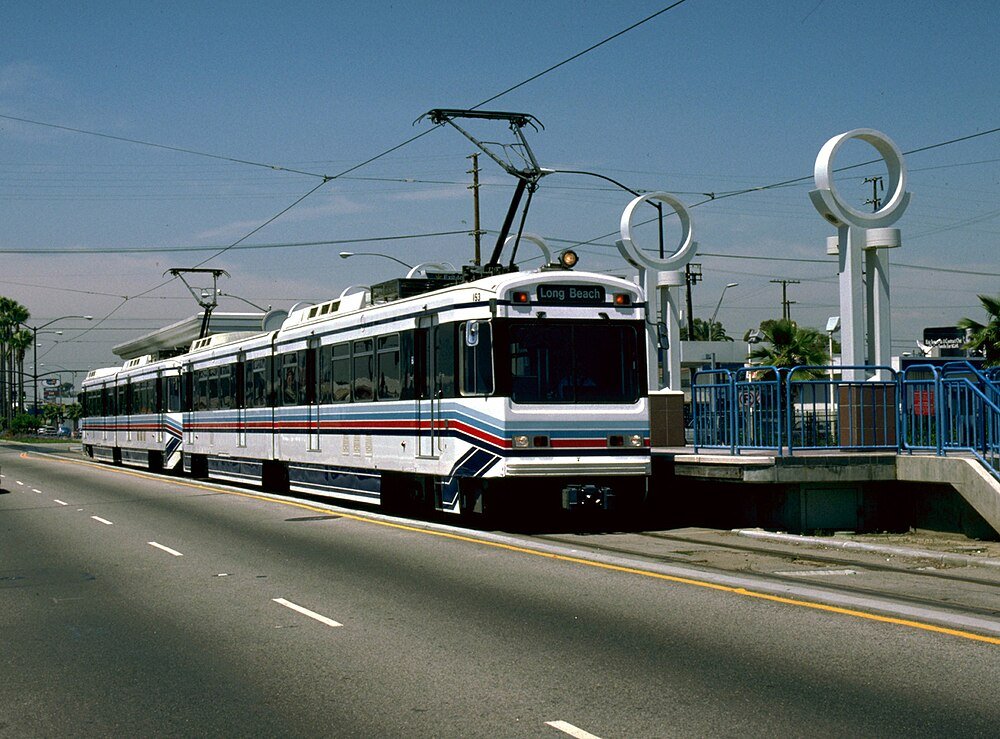 Lättspårvagn vid Long Beach-stationen Modern lättspårvagn på Long Beach-rutten vid urban station med klar himmel och luftledningar