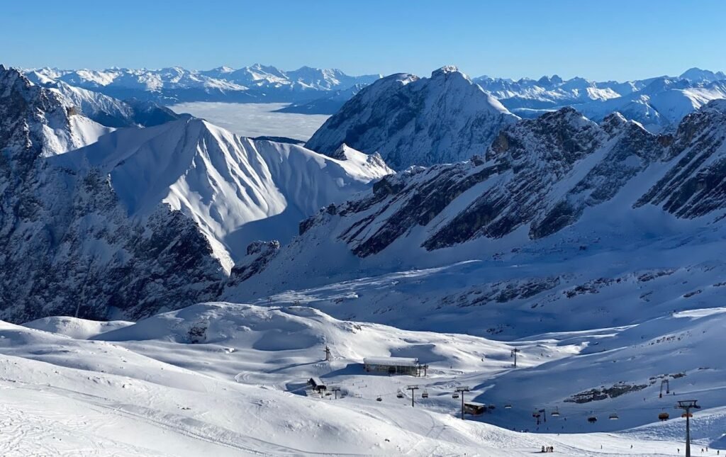 Snötäckta skidbackar och alptoppar på Zugspitze, Tysklands högsta berg och en vinterdagsutflykt från München